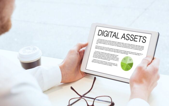 man looking at digital assets on ipad