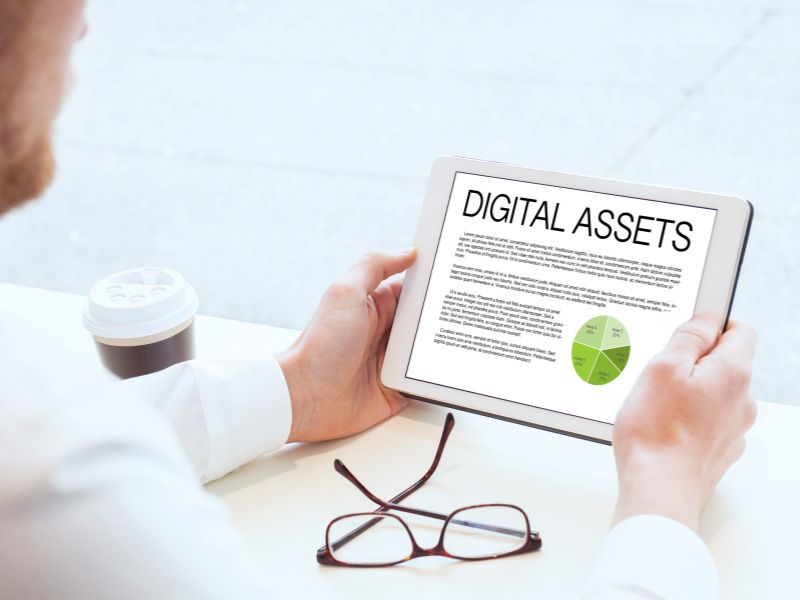 man looking at digital assets on ipad